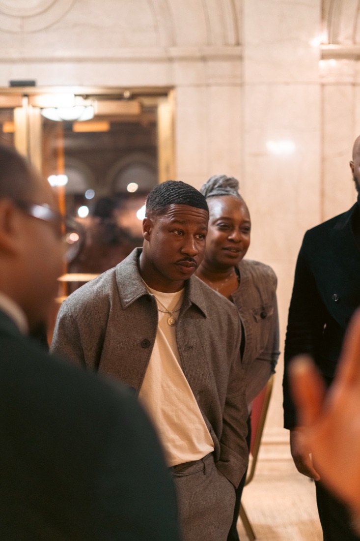 Portrait of CJ Burnett in a marble lobby.